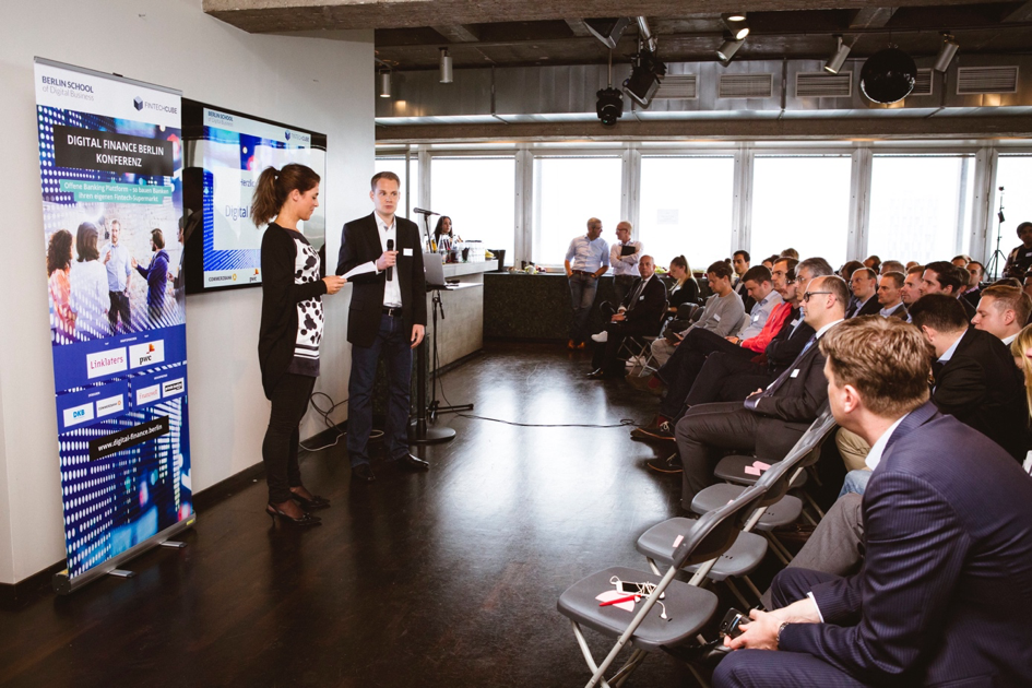 Birte Gall, Managing Director of the Berlin School of Digital Business, and Gregor Puchalla, Managing Director of FinTechCube, welcome those attending Digital Finance Berlin.